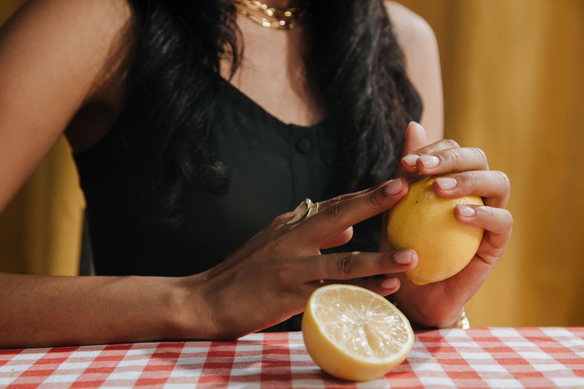 Woman holding fresh lemons, symbolizing freshness and vitality in intimate moments