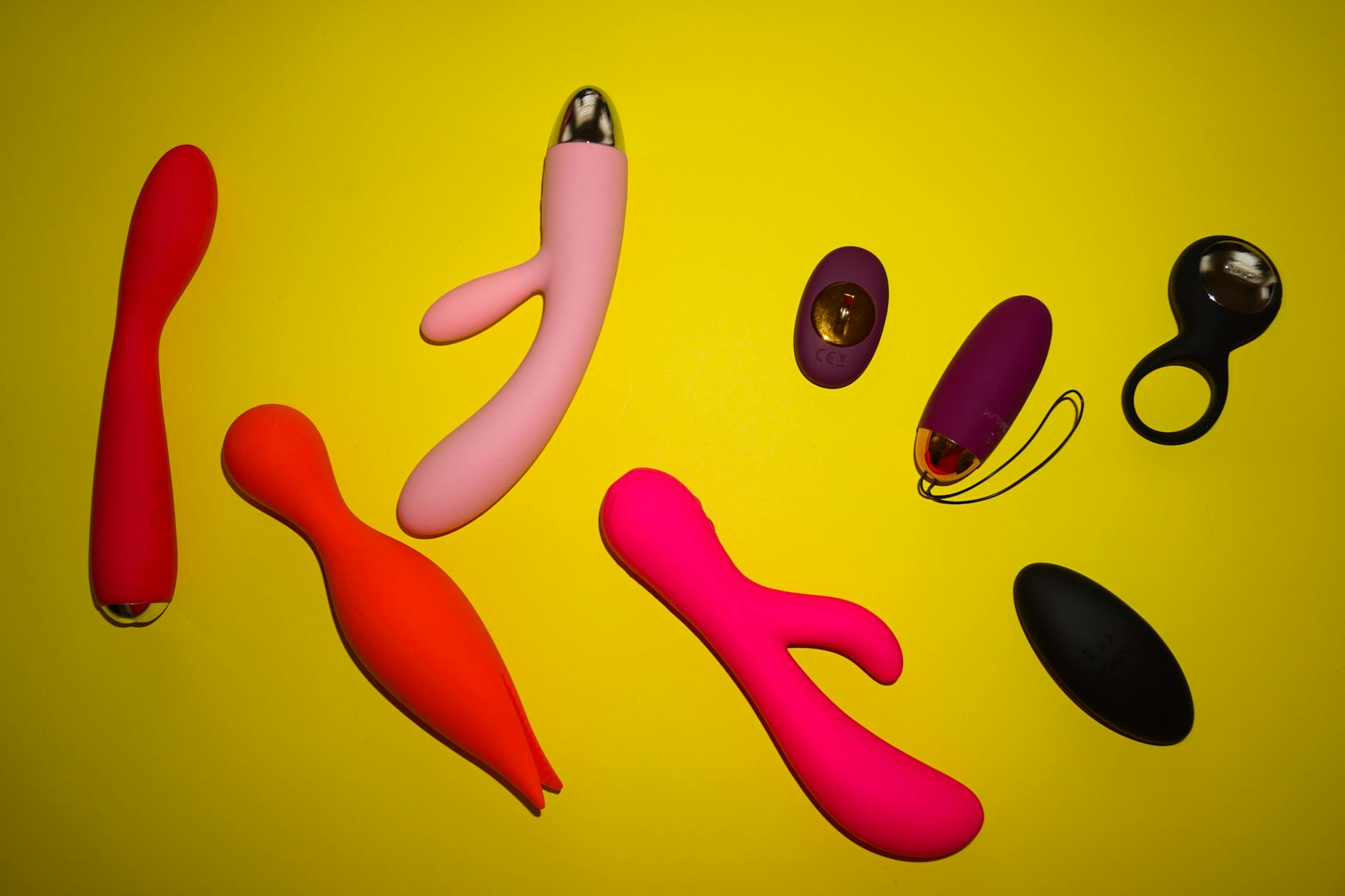 A blue lemon vibrator surrounded by fresh flowers on a yellow background